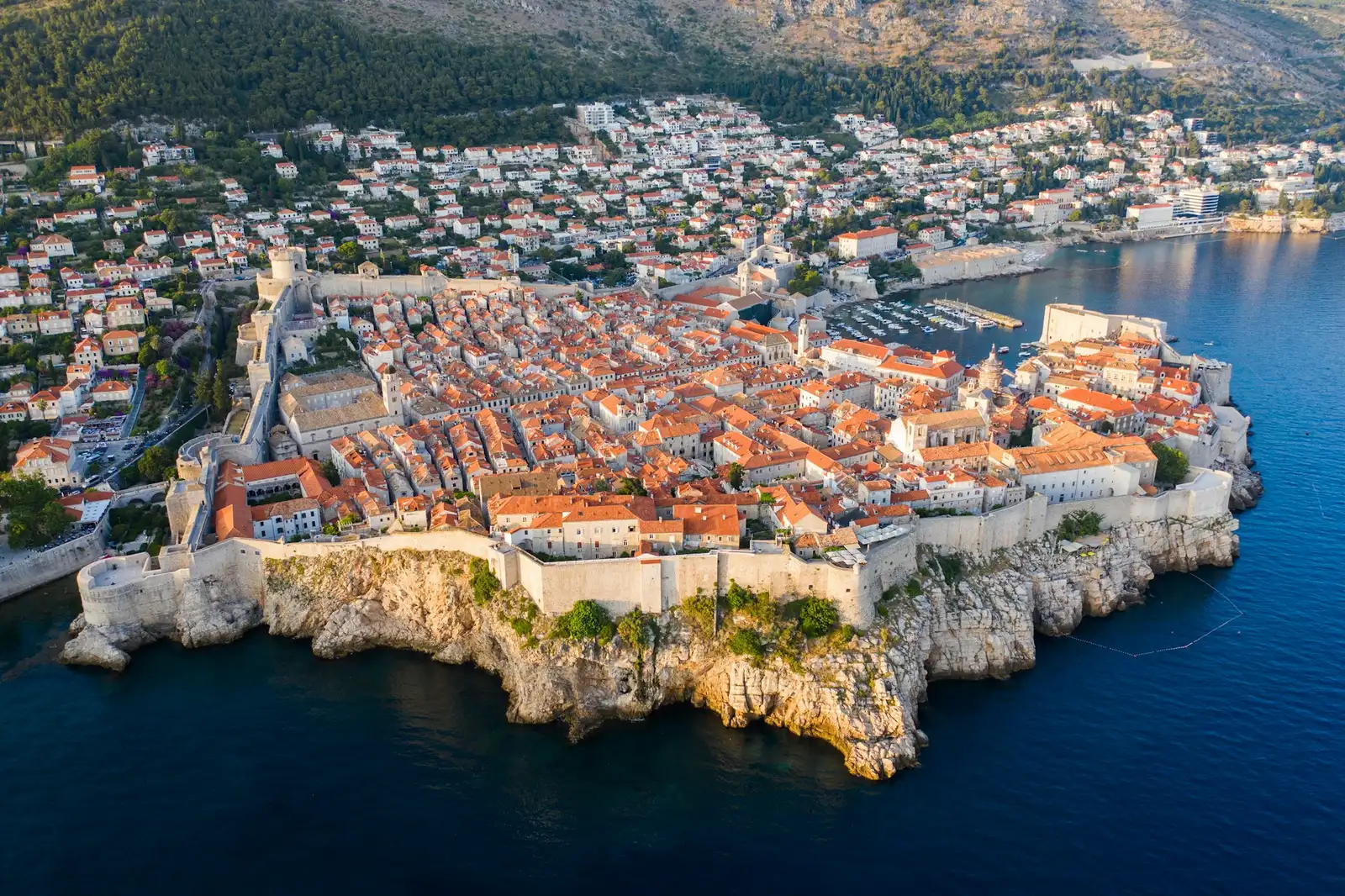 Aerial view of Dubrovnik old town and its walls at golden hour