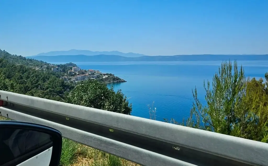 View from a rental car of the sea and a coastal village on the Makarska Riviera, Croatia