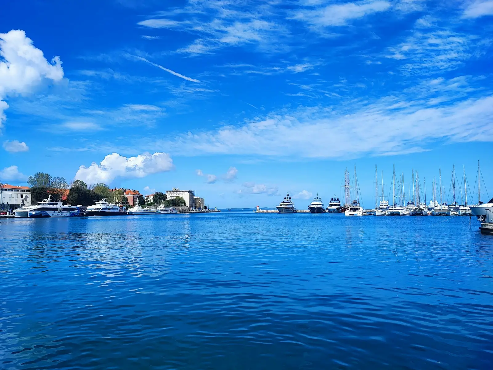 Boats in Zadar harbour with the old town behind